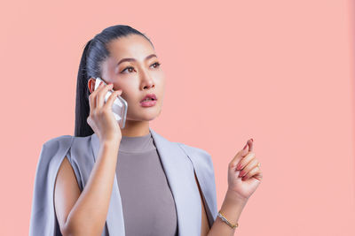 Portrait of a young woman using mobile phone