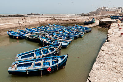 High angle view of boats moored at shore against sky