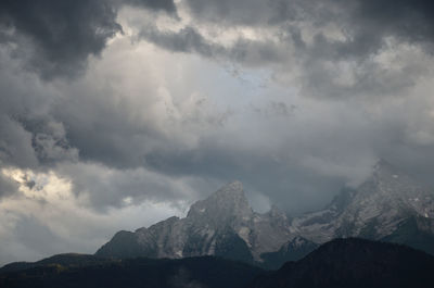 Scenic view of mountains against cloudy sky