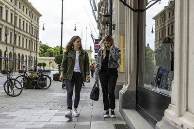 People walking on footpath in city