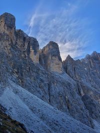 Low angle view of rocky mountains against sky