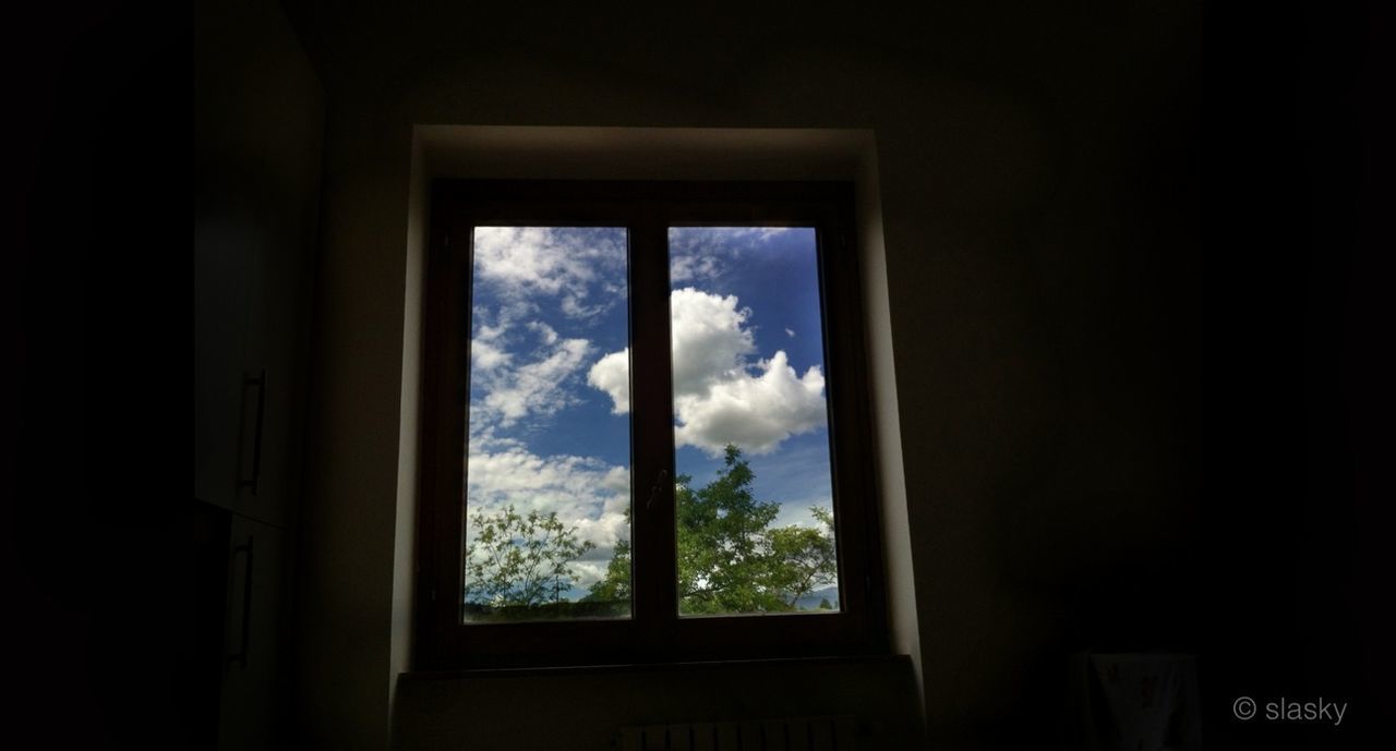 window, indoors, transparent, glass - material, dark, sky, home interior, silhouette, tree, house, looking through window, day, no people, copy space, built structure, low angle view, architecture, sunlight, nature, glass