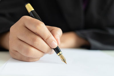 Close-up of person hand holding paper