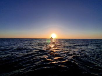 Scenic view of sea against clear sky during sunset