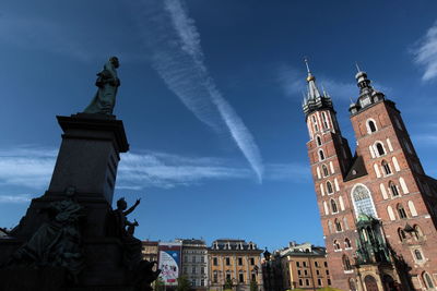 Low angle view of statue by wawel cathedral against sky
