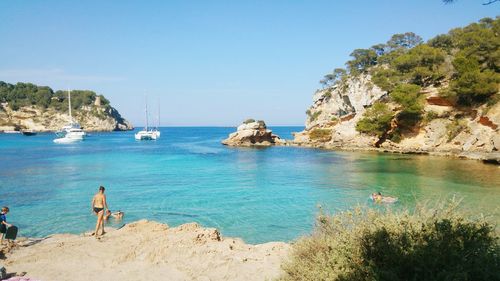 Tourists swimming in sea