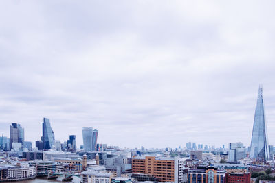 Skyscrapers against cloudy sky