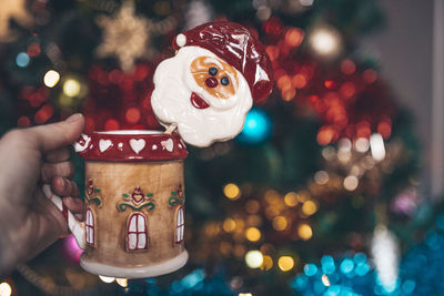 Christmas cup in hand of woman