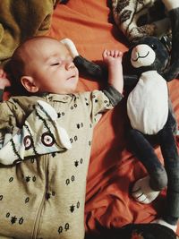 High angle view of cute baby lying on bed