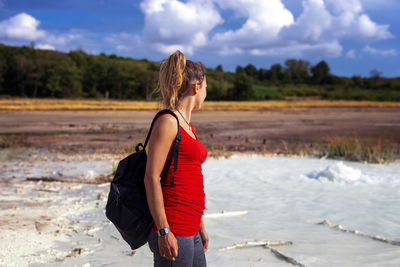 Hiker visits the caldera, a small circular crater with a marsh of sulphurous waters from the volcano