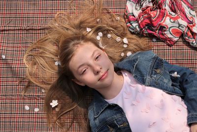 Portrait of woman lying down on bed