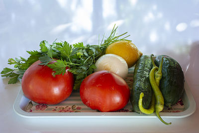 Close-up of fruits and vegetables in plate on table