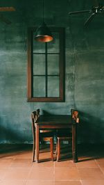 Empty chairs and table against wall at home