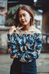 Portrait of woman standing outdoors