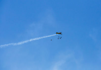 Low angle view of airplane flying in sky