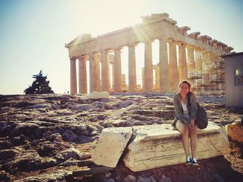 Woman standing in front of old ruins