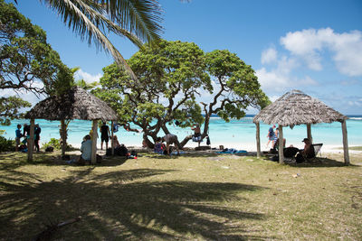 People at beach against sky