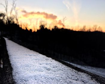 View of snow covered landscape during sunset