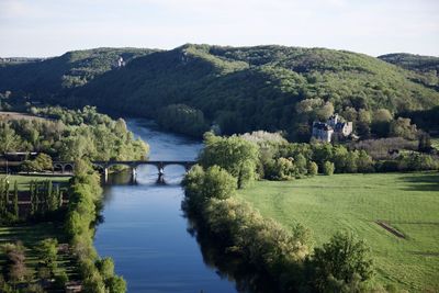 Scenic view of river amidst mountains against sky