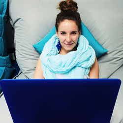 Portrait of young woman sitting on chair
