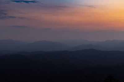 Scenic view of silhouette mountains against sky during sunset