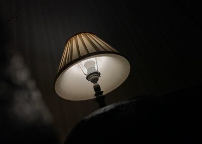 Low angle view of illuminated lamp at night