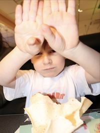 Cute boy eating food at home