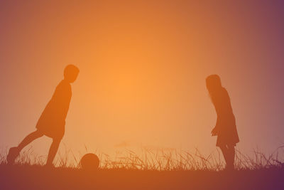 Silhouette person against sky during sunset