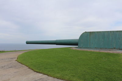 Built structure on field against sky