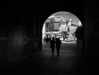 People walking in illuminated city at night