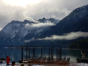 Scenic view of lake by mountains against sky