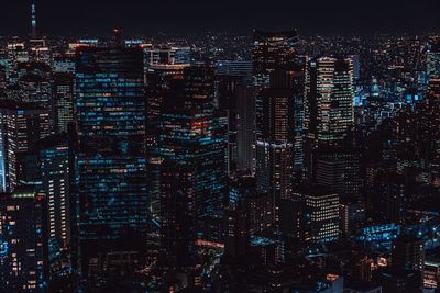 High angle view of illuminated buildings in city at night