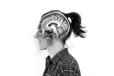 Profile view of man with ponytail against white background