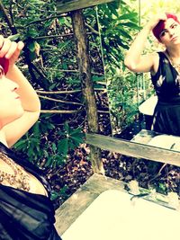 Midsection of woman standing against trees