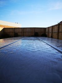 Swimming pool by building against sky