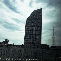 Low angle view of building against cloudy sky