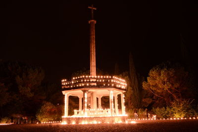 Illuminated building against sky at night