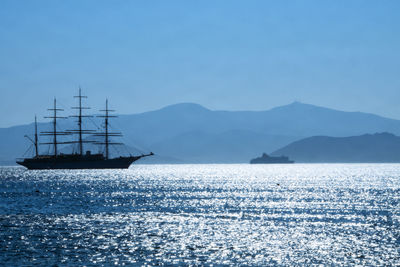 Sailboat sailing in sea against sky