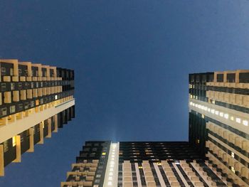 Low angle view of buildings against clear blue sky