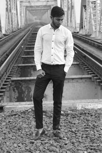 Full length of man standing on railroad track