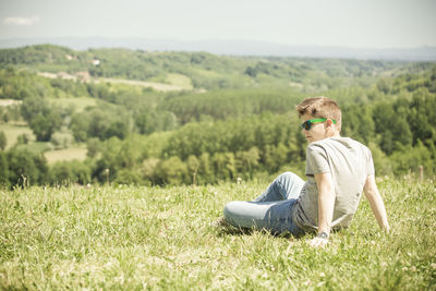 Man sitting on grassy field