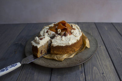 Close-up of carrot cake served on wooden table 