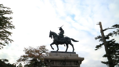 Low angle view of statue against sky