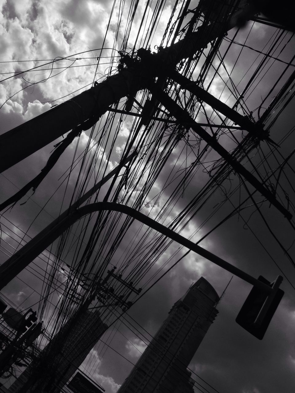 low angle view, sky, built structure, architecture, connection, cable, power line, cloud - sky, electricity pylon, electricity, building exterior, power supply, cloud, tall - high, outdoors, technology, no people, cloudy, day, dusk