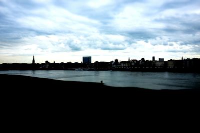 View of cityscape against cloudy sky