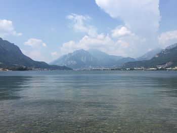 Scenic view of sea and mountains against sky