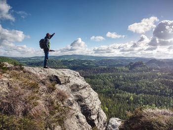 Travel photographer on mountain summit works. man like to travel and photography taking pictures