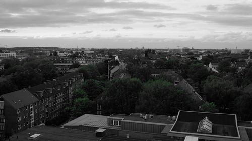 Buildings against cloudy sky
