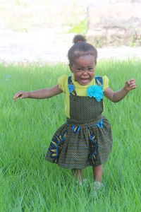 Portrait of crying girl on grassy field