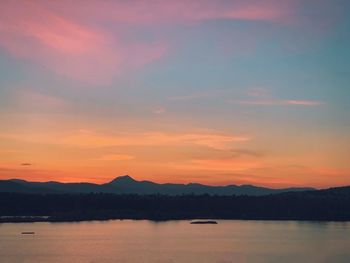 Scenic view of lake against romantic sky at sunset